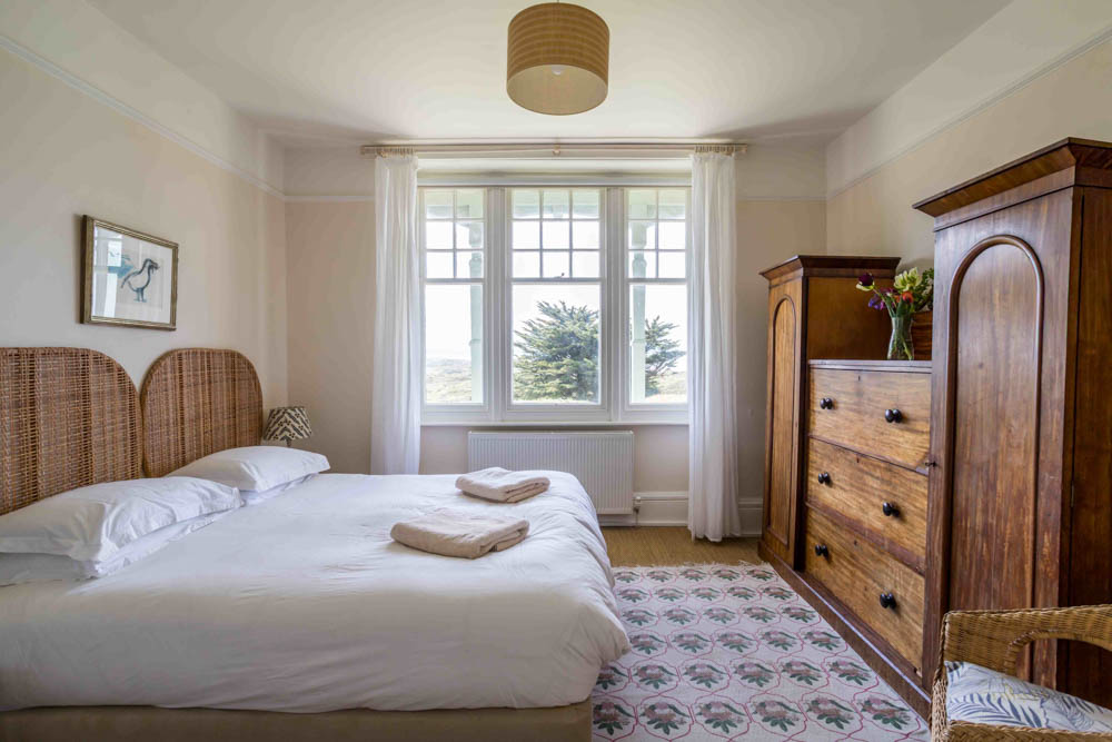 Master double bedroom in Knelle Lodge Apartment 1 with antique wardrobe and sea views over Braunton Burrows